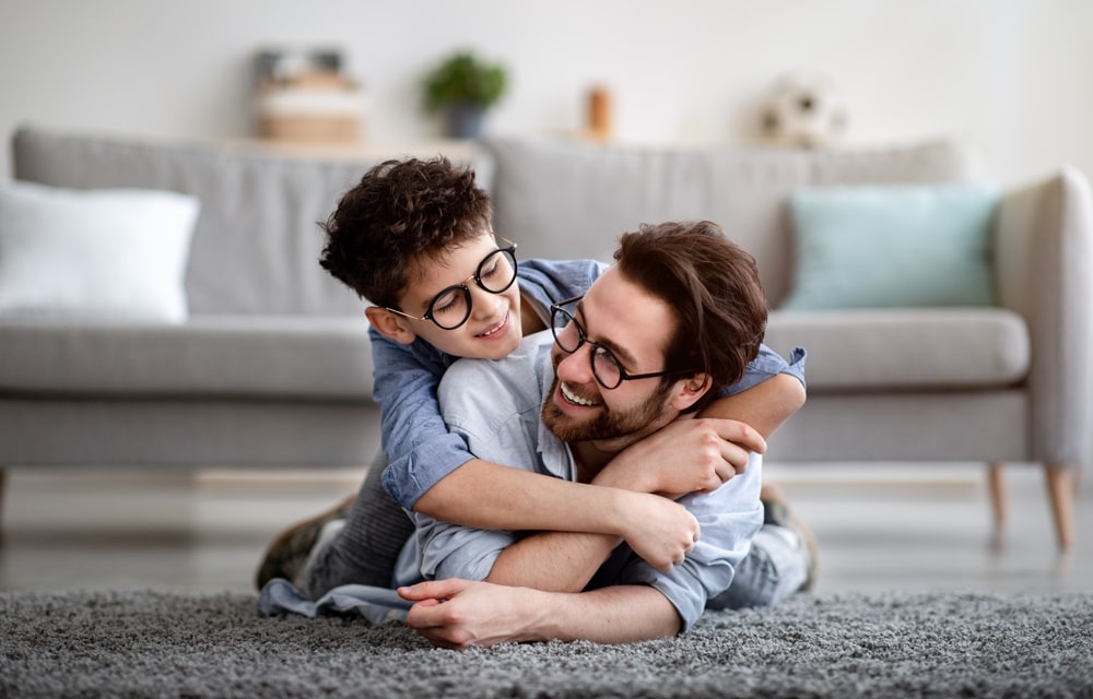 boy with dad happier after anxiety therapy