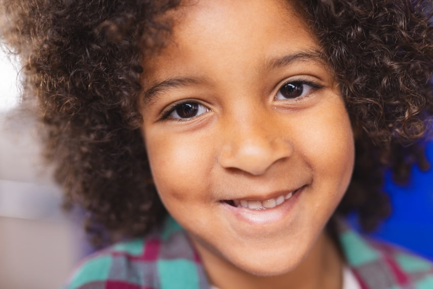 close up of child smiling after solution-focused therapy in brighton