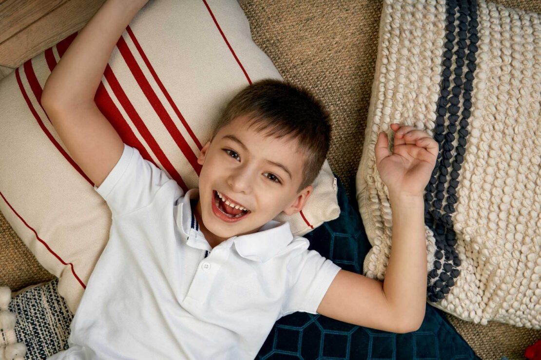 happy young boy staring in the camera lightwater child therapy