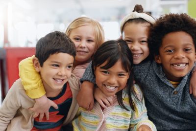 Science, portrait and group of kids with smile at convention, expo or exhibition with happiness. St.